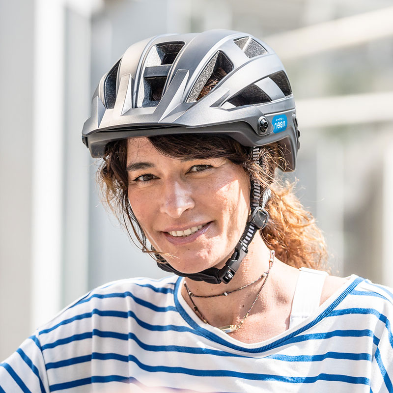 portrait of a woman wearing a bike helmet connected by ricon