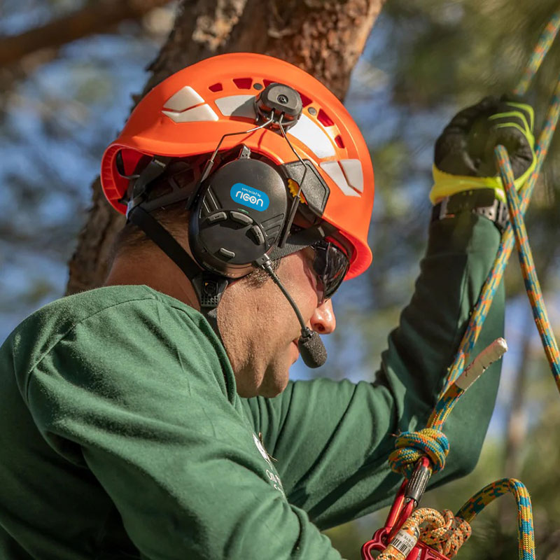 portrait of a man who cuts trees wearing a headset connected by ricon